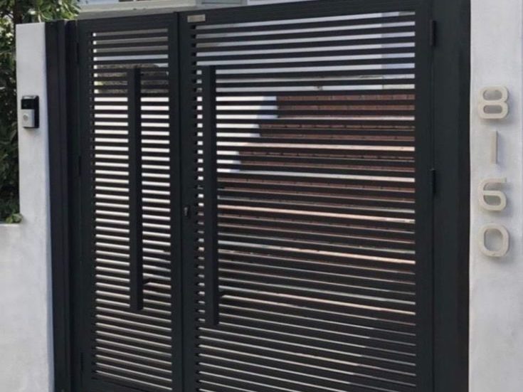 Slatted steel double gate with house number by The Classic Forge
