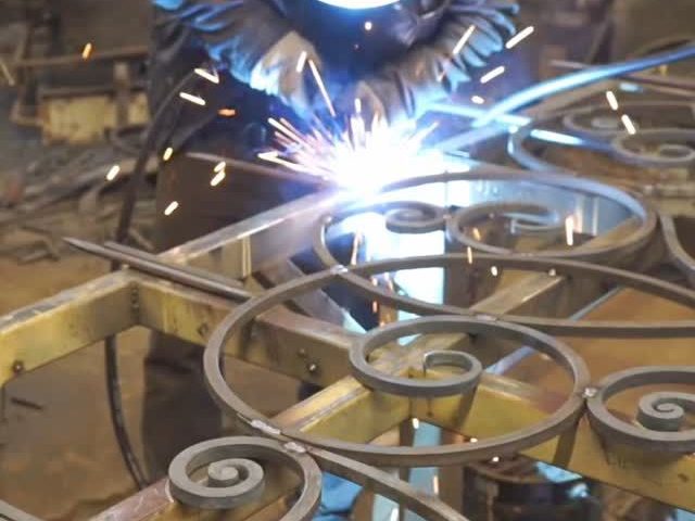 Hand-forged wrought iron scrollwork being welded by The Classic Forge